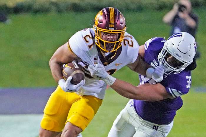 Sep 23, 2023; Evanston, Illinois, USA; Minnesota Golden Gophers running back Bryce Williams (21) tries to run past Northwestern Wildcats linebacker Bryce Gallagher (32) during the first quarter at Ryan Field.